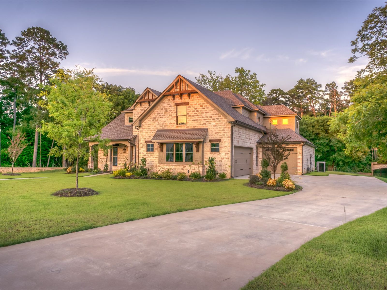 New country home with gable roof and stone cladding